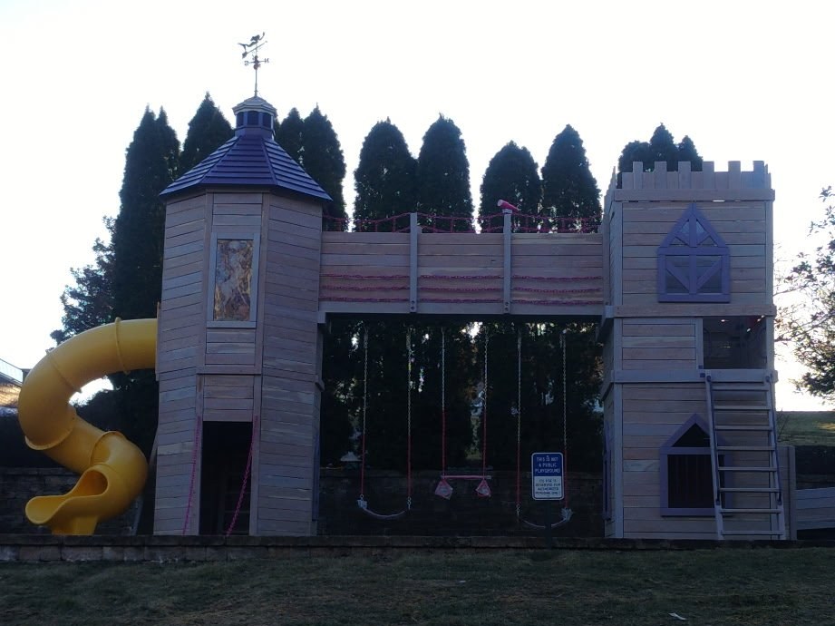 The life-size HaHa Tonka Castle playset with turret, bridge and spiral slide by Ozark Playsets
