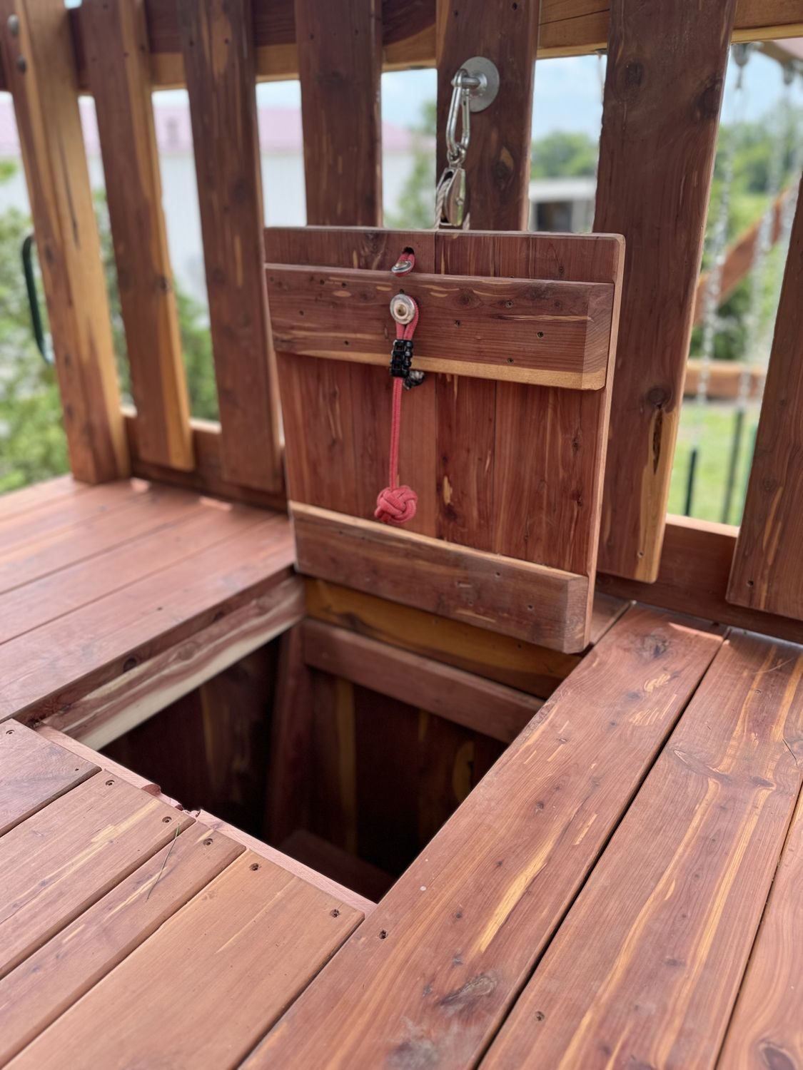 Cedar trap door inside an Ozark playset fort