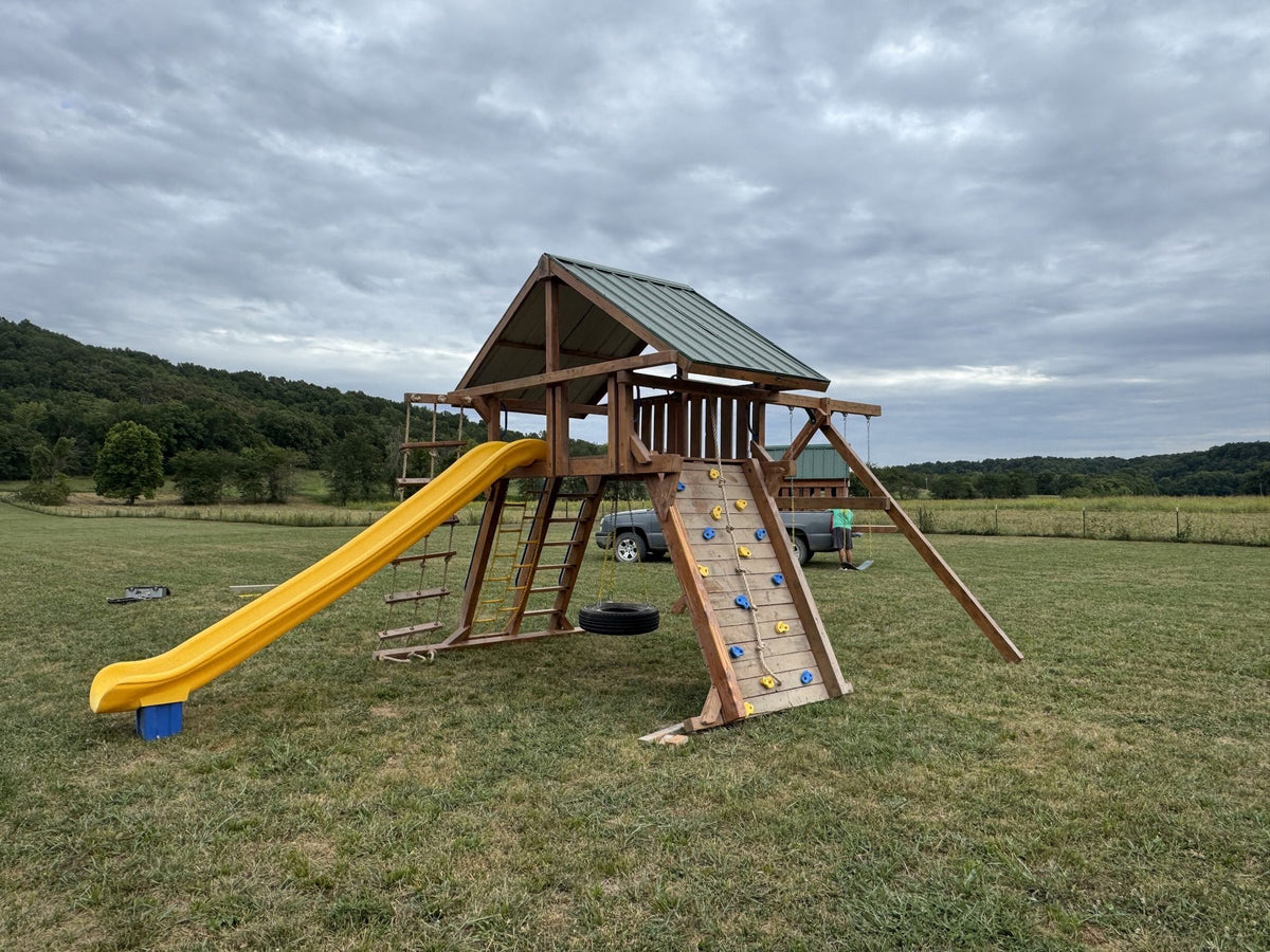 Ozark playset with yellow slide in an open field